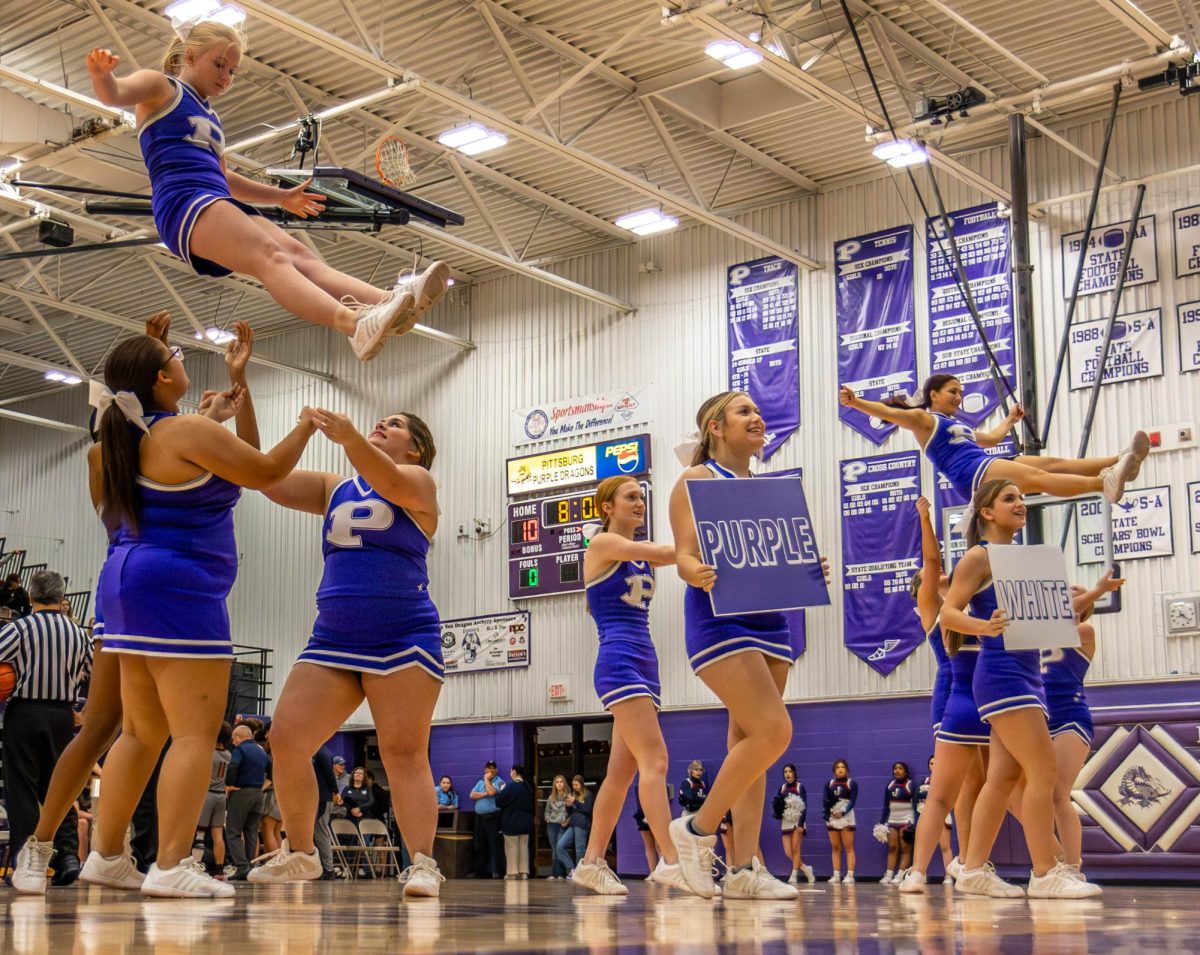 PHS cheerleaders perform at a Varsity Basketball game during a timeout.