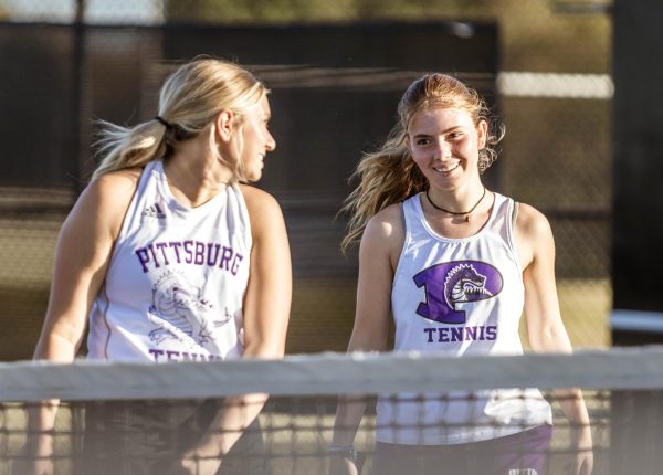 After junior Valentina Fernandez successfully sprints to make a return over her back, she and her partner, junior Aurora Parker-Collins, celebrate. "This is my first time playing tennis and I love it," Fernandez said. "It's so cool and I have a lot of fun."